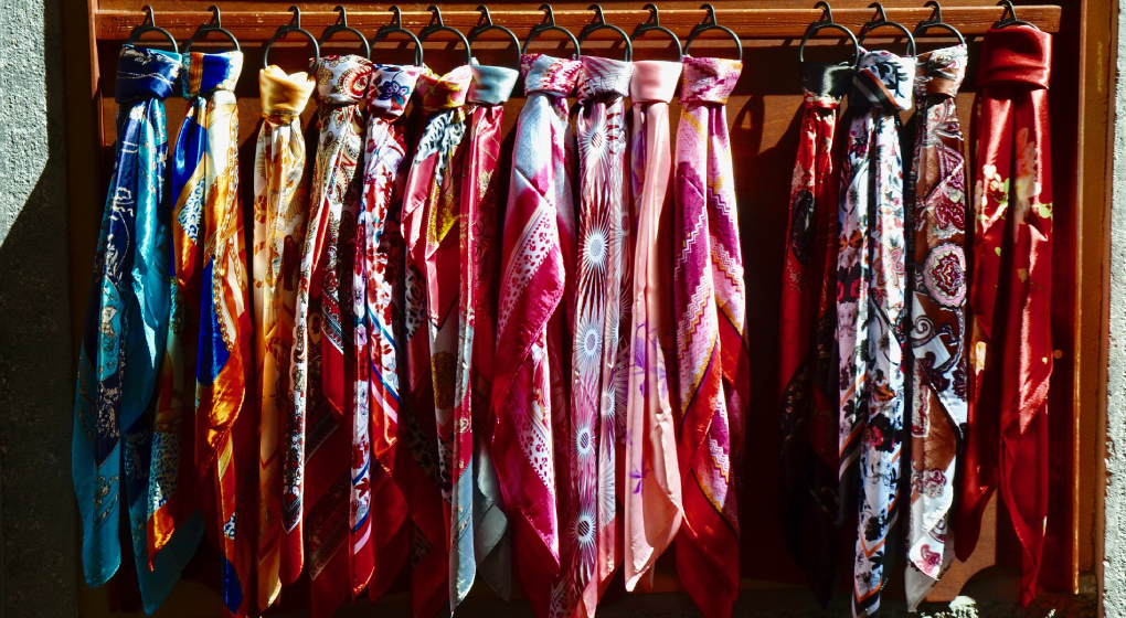 Many foulard hanging in the closet