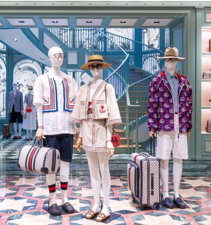 Visitors take photos of a suitcase on display during the Louis